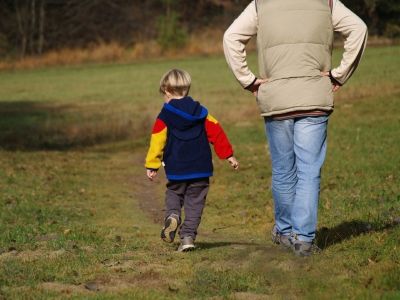 father and son walking in a field